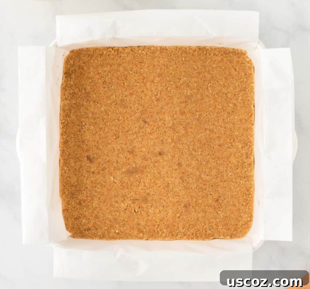 Easy No-Bake Pumpkin Cheesecake Bars 14 graham cracker crust firmly pressed into the bottom of a parchment-lined baking pan
