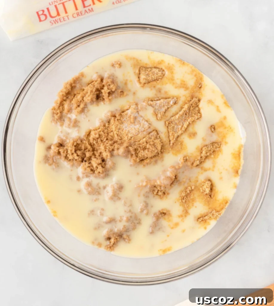 Easy No-Bake Pumpkin Cheesecake Bars 7 crushed graham crackers and melted butter being mixed in a bowl