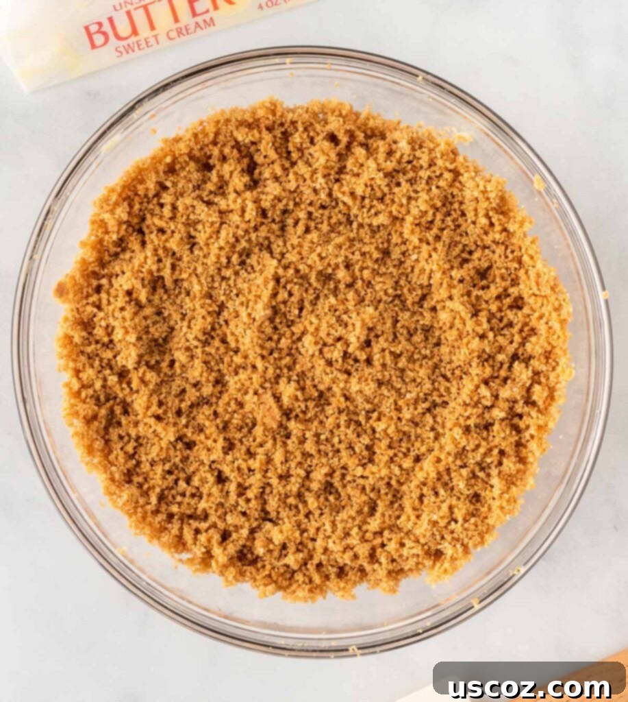 Easy No-Bake Pumpkin Cheesecake Bars 8 a bowl of mixed graham cracker crust ingredients, ready to be pressed