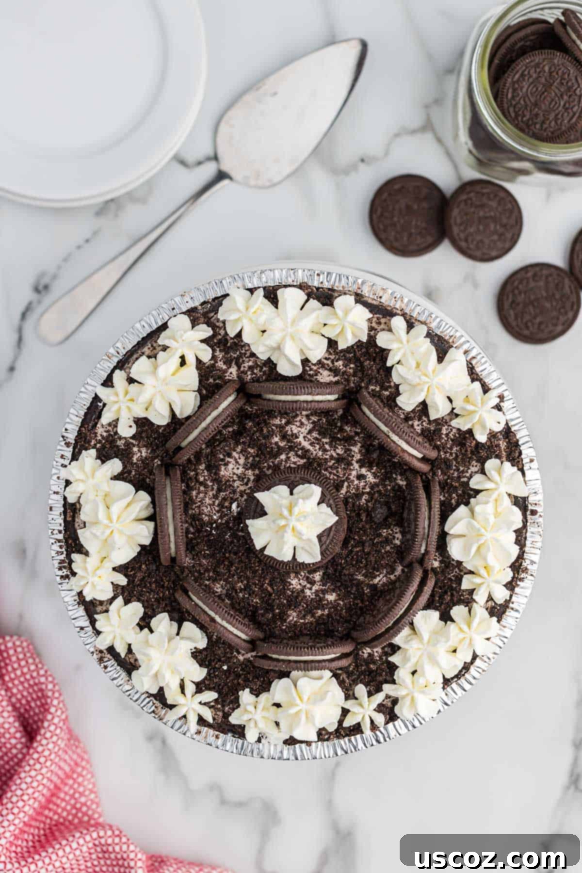 Oreo Bliss Pie 3 A delicious No-Bake Oreo Pie resting in a pie dish, ready to be served, highlighting its smooth, dark filling and cookie crust.