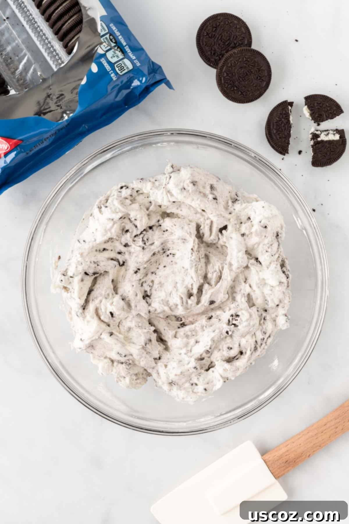 Oreo Bliss Pie 7 The fully mixed Oreo pie filling, a dark, creamy mixture with visible crushed Oreo pieces, ready to be poured into the crust.