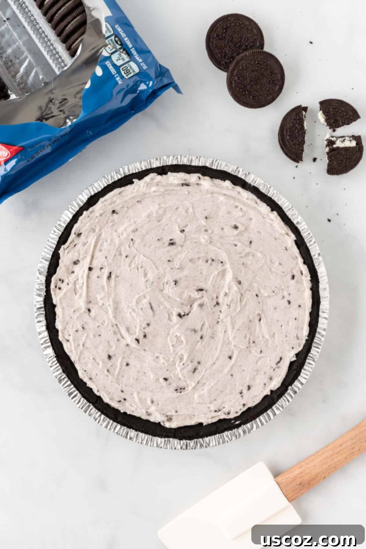 Oreo Bliss Pie 8 The smooth, dark Oreo pie filling has been perfectly spread into an Oreo pie crust, creating a level surface ready for chilling and toppings.