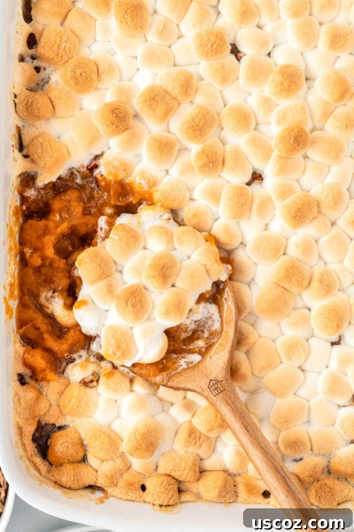 Golden Sweet Potato Marshmallow Bake 21 scooping sweet potato casserole from the dish