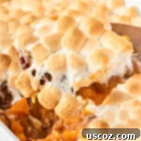Golden Sweet Potato Marshmallow Bake 22 scooping sweet potato casserole from the dish