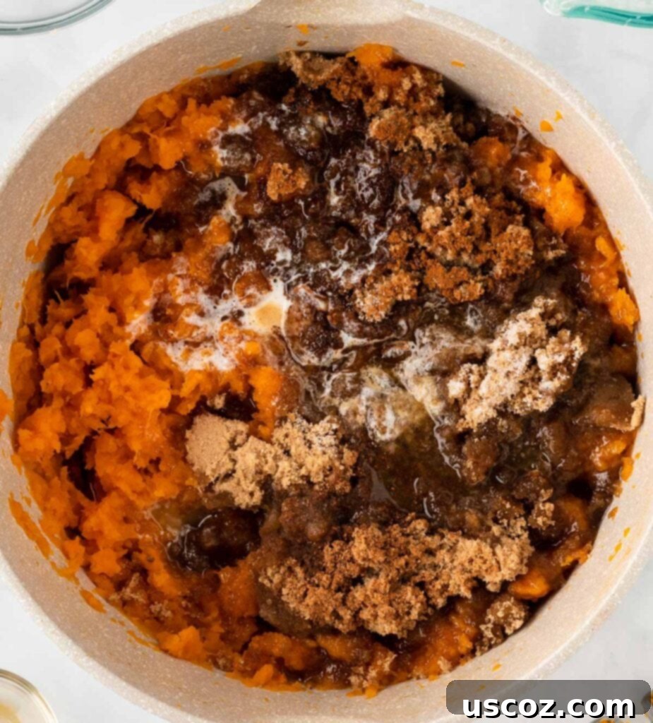 Golden Sweet Potato Marshmallow Bake 10 adding the sweetener and spices to mashed sweet potatoes