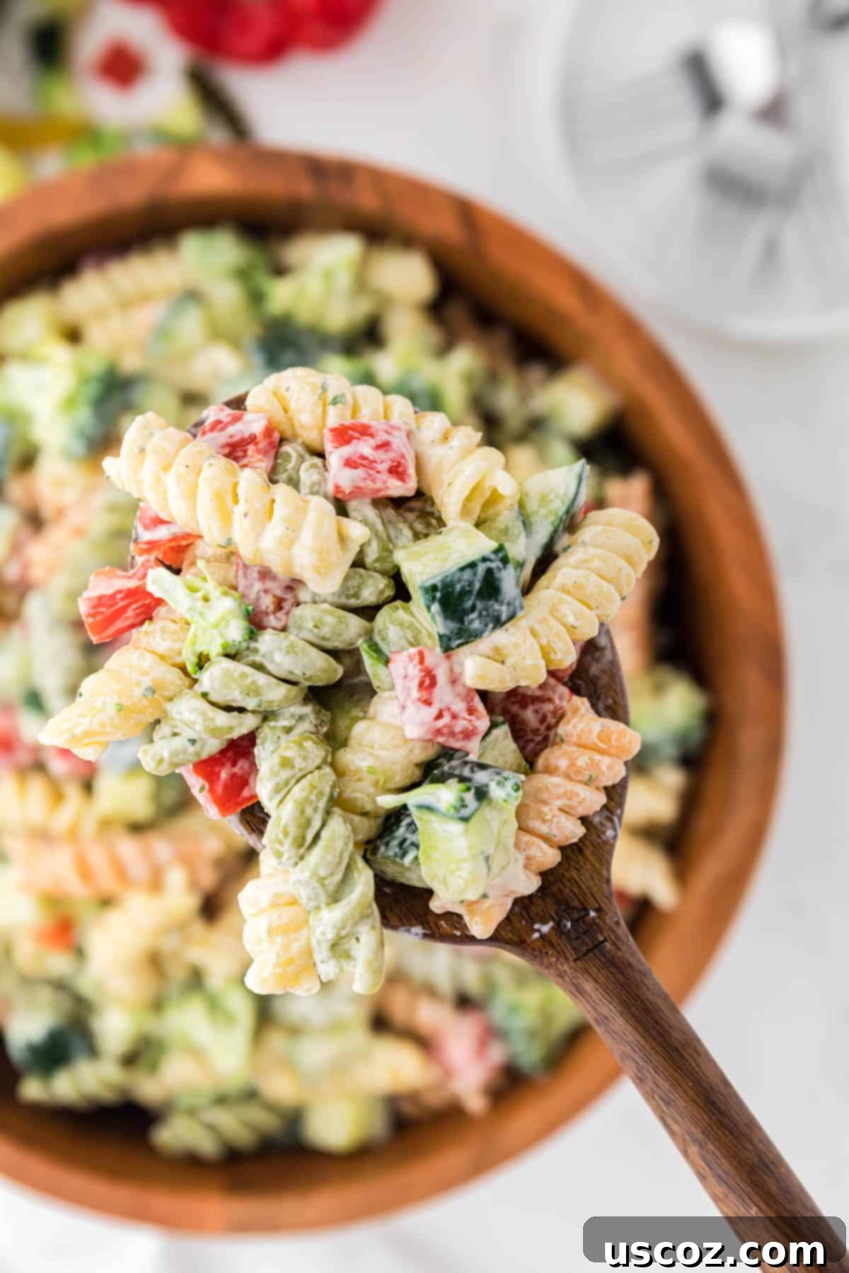 Creamy Ranch Pasta Salad 3 wooden spoon taking a scoop of pasta salad from the bowl