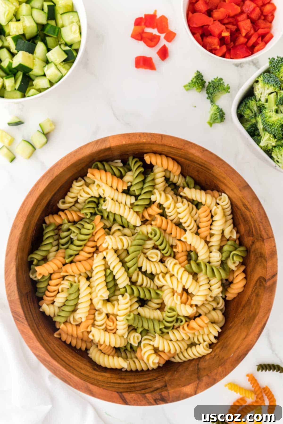 Creamy Ranch Pasta Salad 8 cooked tri color rotini in a wooden bowl