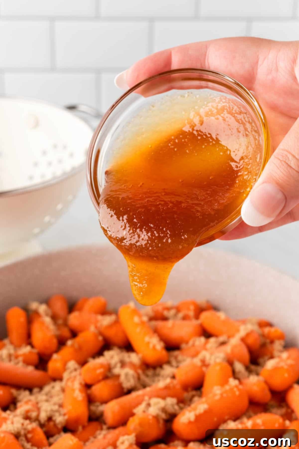 Sweet & Sticky Honey Brown Sugar Carrots 8 pouring honey onto the brown sugar carrots