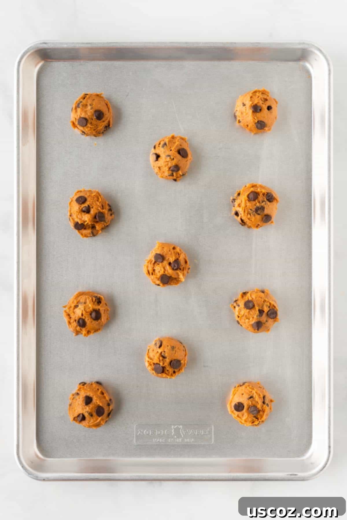 Easy Pumpkin Cake Mix Cookies 11 cake mix pumpkin cookie dough balls on a baking sheet