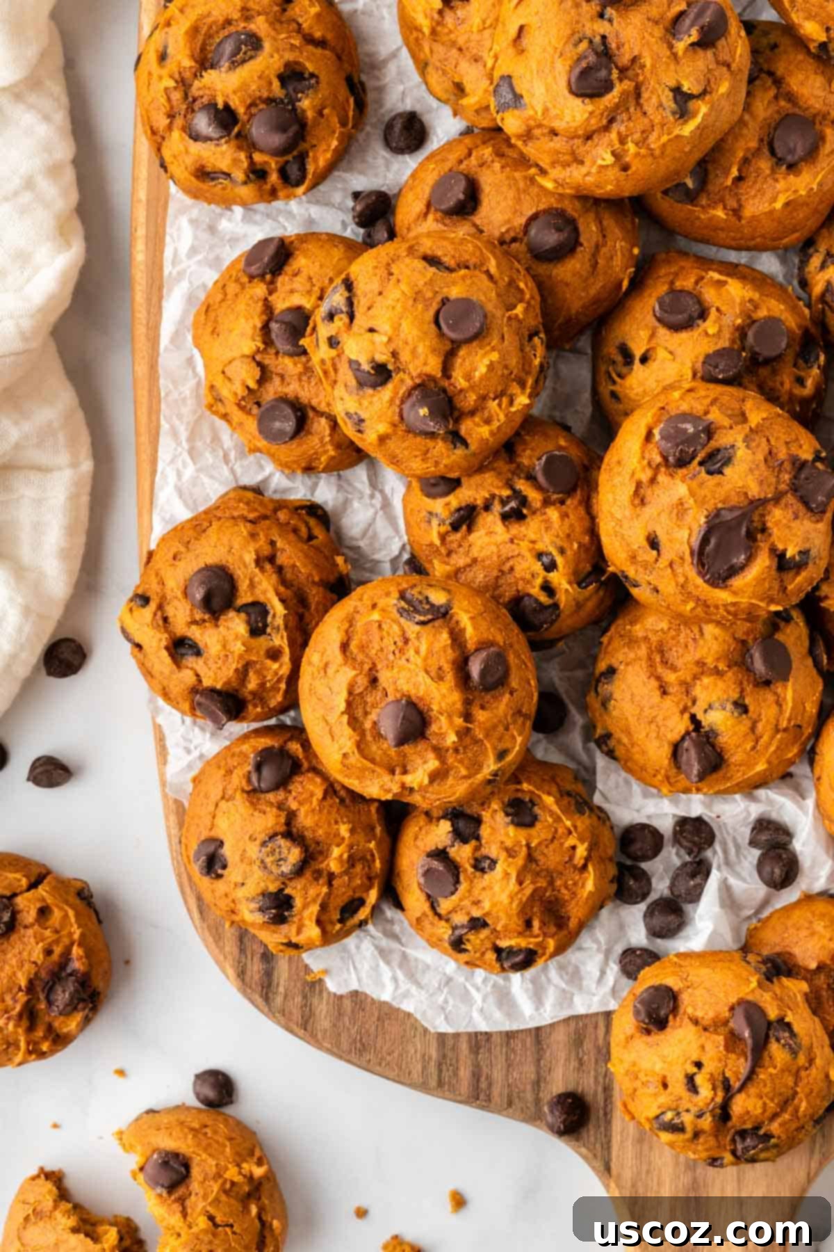 Easy Pumpkin Cake Mix Cookies 15 cake mix pumpkin cookies on a wooden cutting board