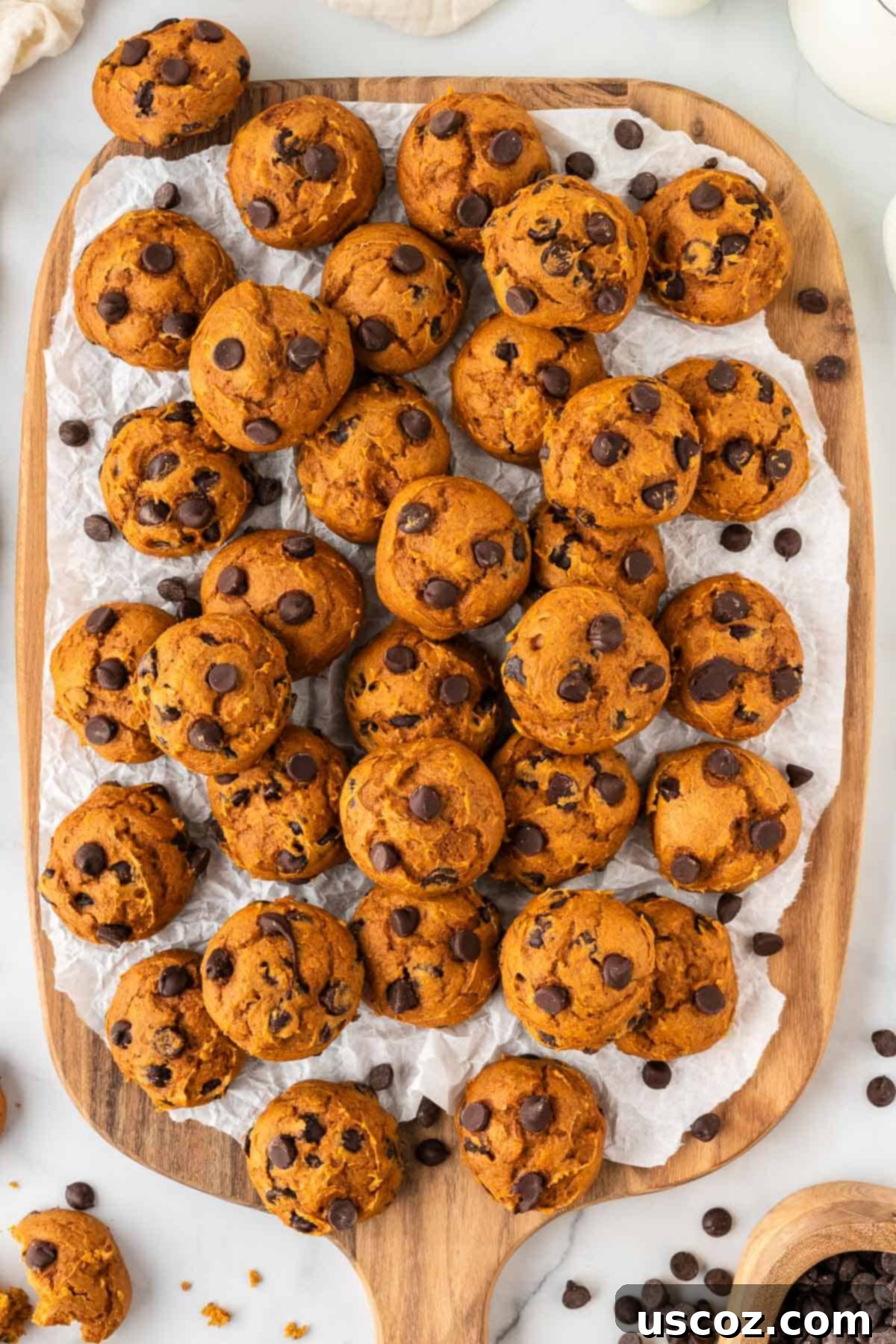 Easy Pumpkin Cake Mix Cookies 4 cake mix pumpkin cookies on a wooden cutting board