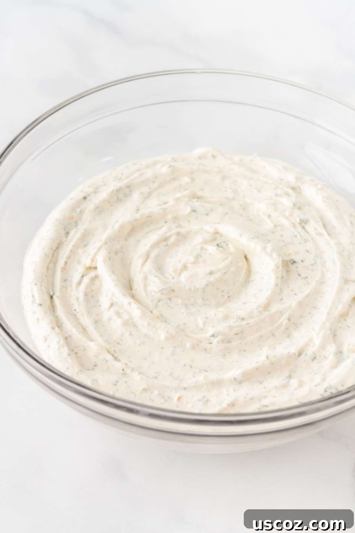 Garden Fresh Dip 7 A beautifully presented bowl of creamy homemade veggie dip, garnished with a sprinkle of fresh herbs, showcasing its smooth texture and inviting appearance after chilling.