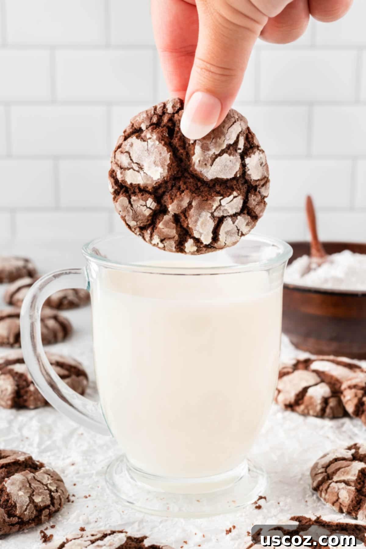 Irresistible Cake Mix Crinkles 14 dipping a cookie in milk