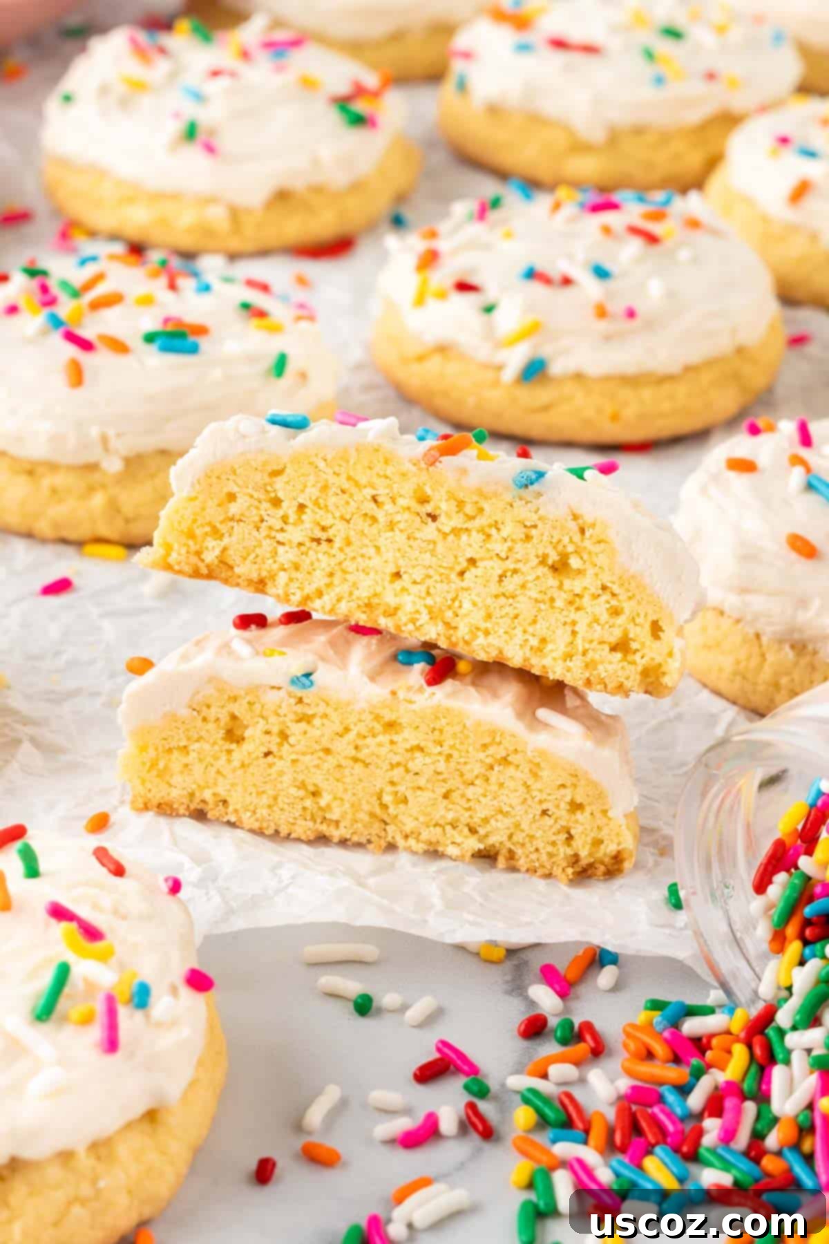 Effortless Cake Mix Sugar Cookies 14 sugar cookie cut int half to show how soft it is
