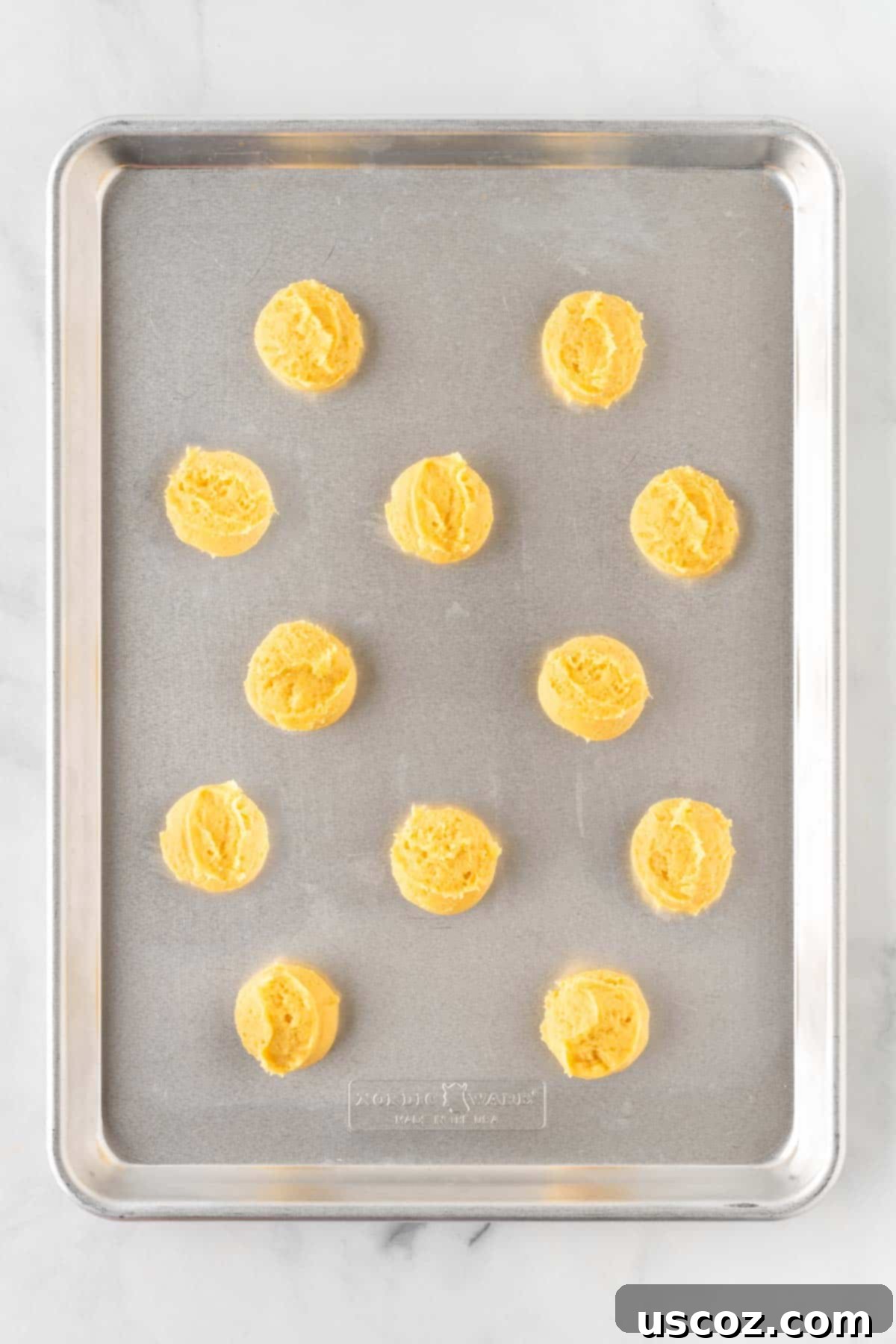 Effortless Cake Mix Sugar Cookies 8 sugar cookie dough balls on a baking sheet