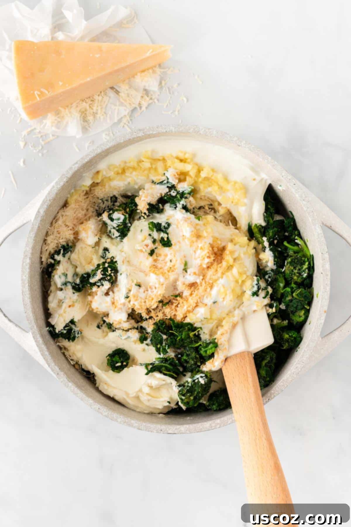 Decadent Creamy Spinach Dip 6 stirring the ingredients together