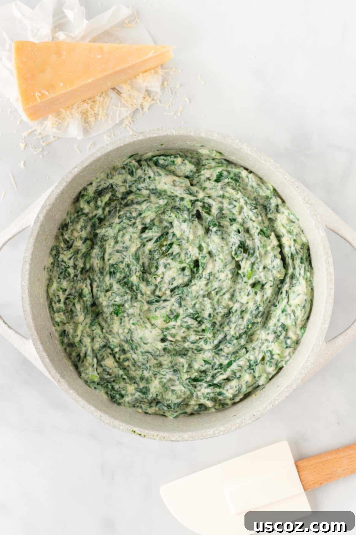 Decadent Creamy Spinach Dip 7 melted creamy spinach dip in a sauce pan