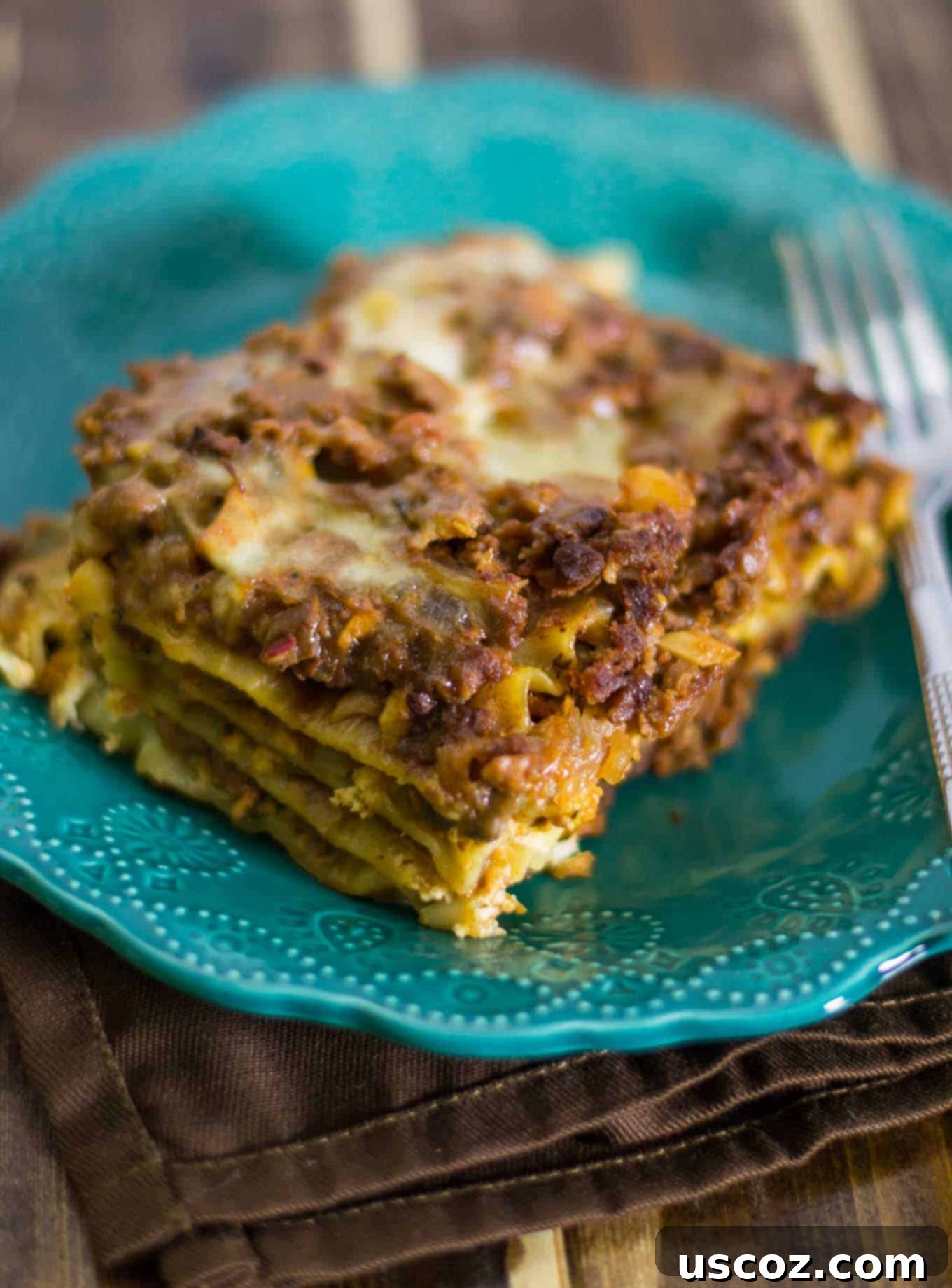 Layers of meaty vegetarian lasagna being assembled in a baking dish