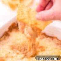 Rich Cream Cheese Bean Dip 11 dipping a tortilla chip into bean dip