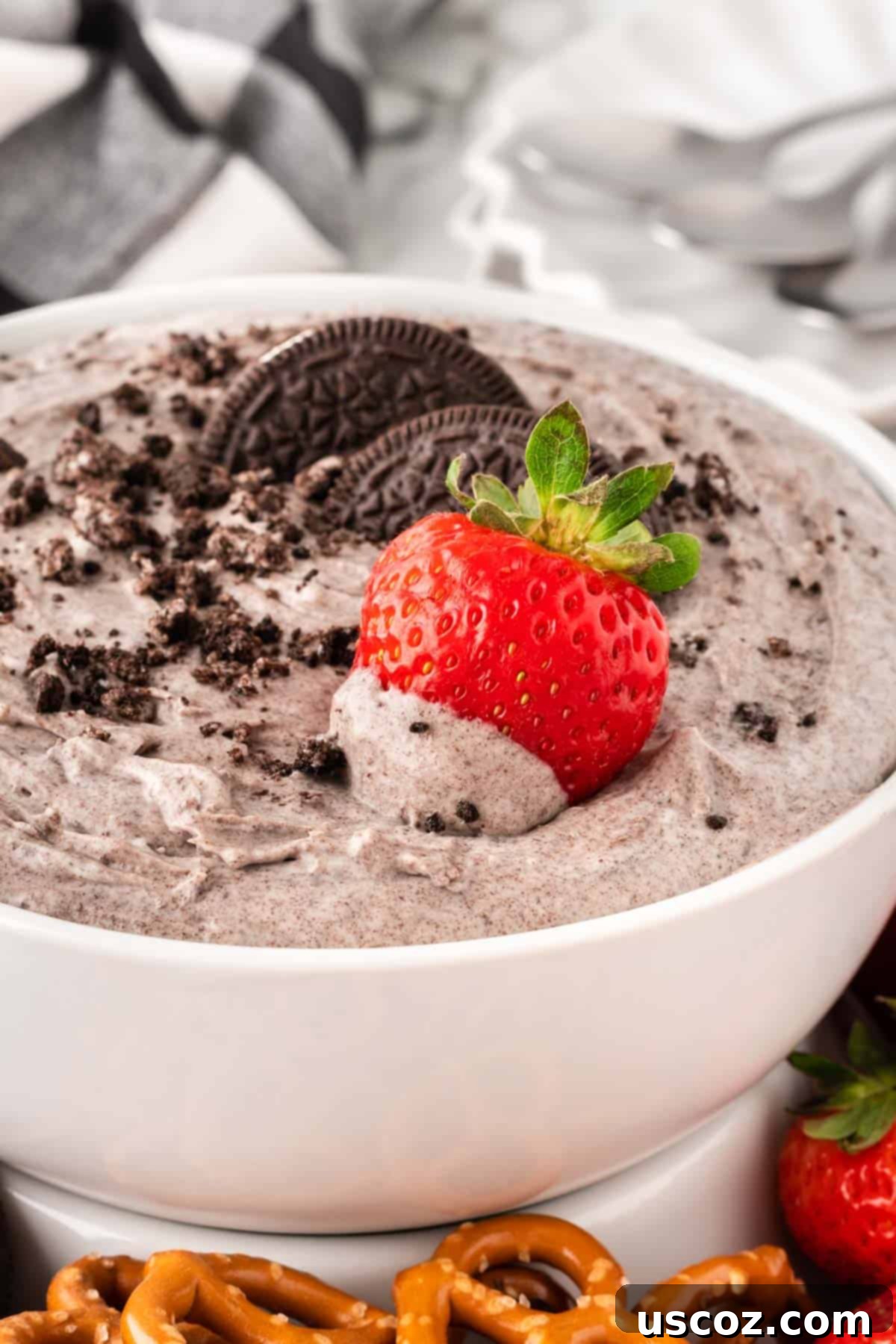 Creamy Oreo Dip 12 A close-up of a strawberry being dipped into the creamy Oreo dip, highlighting the perfect consistency