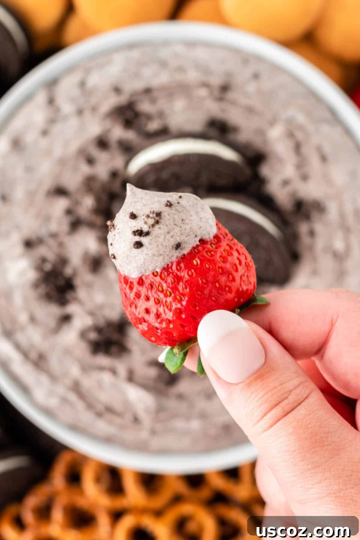 Creamy Oreo Dip 3 Dipping a fresh strawberry into creamy Oreo dip