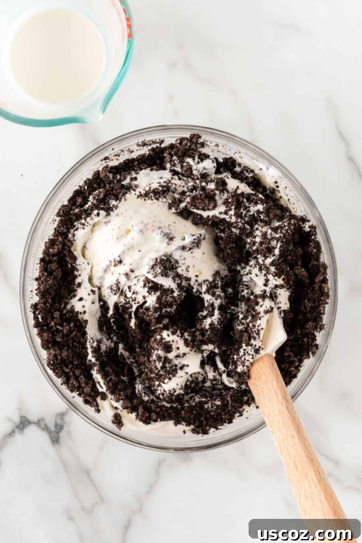Creamy Oreo Dip 8 Gently mixing crushed Oreos into the dessert dip