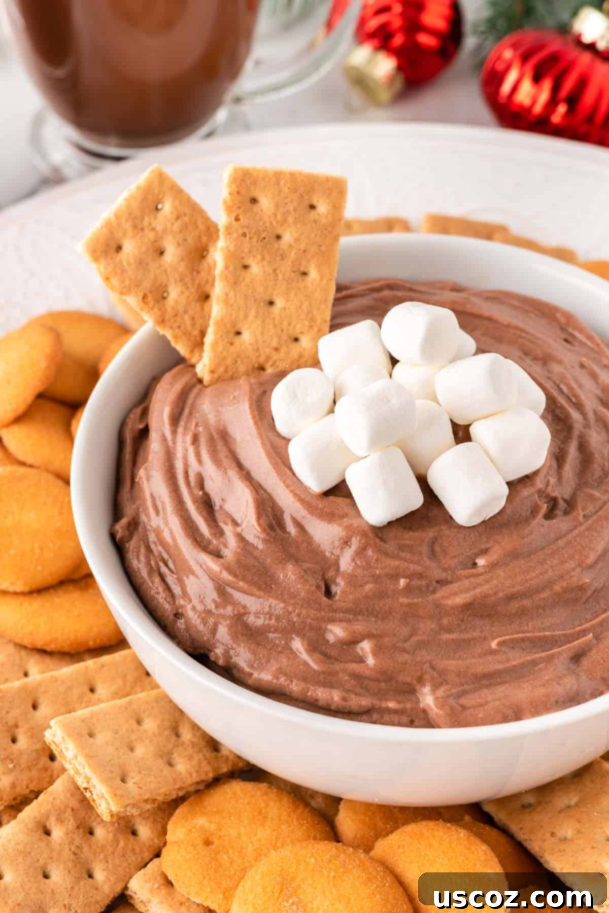 Cozy Chocolate Dip 2 Hot chocolate dip topped with mini marshmallows, ready to be served on a festive platter.