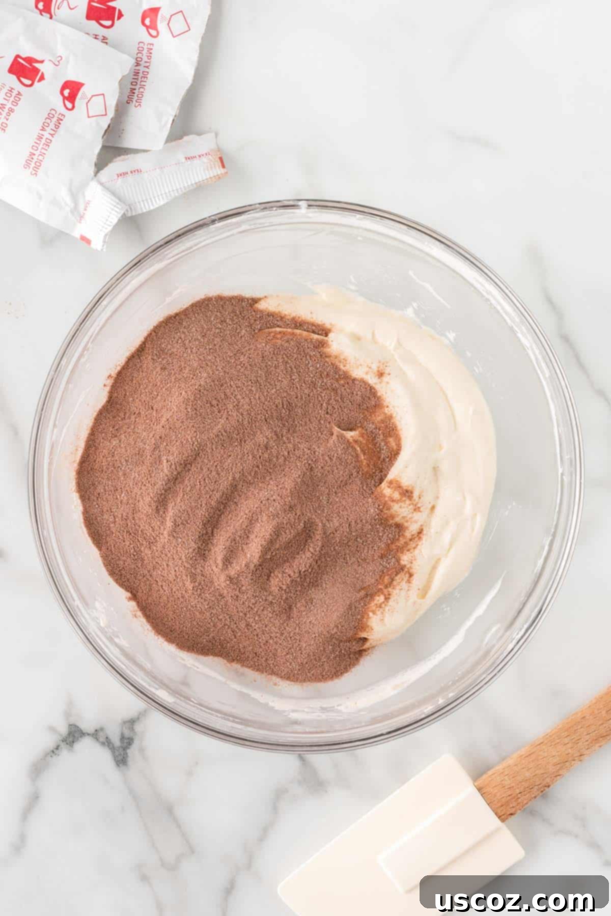 Cozy Chocolate Dip 9 Hot chocolate mix being added to the whipped cream cheese mixture.
