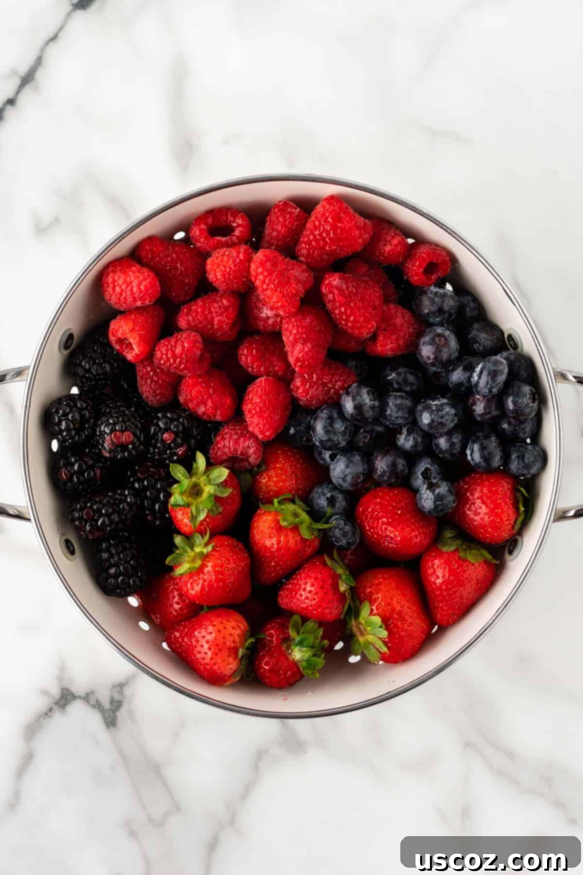 Creamy Cheesecake Fruit Delight 8 raspberries, blackberries, blueberries, and strawberries in a strainer