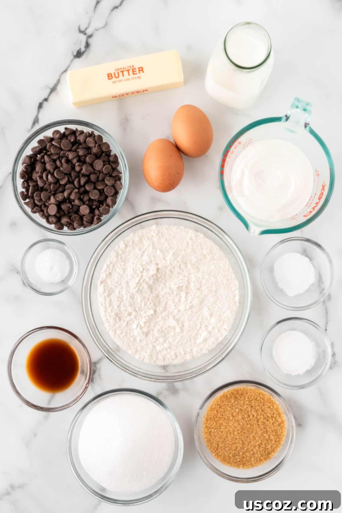 Perfect Bakery Style Chocolate Chip Muffins 4 All the fresh ingredients laid out on a table, ready to make sour cream chocolate chip muffins