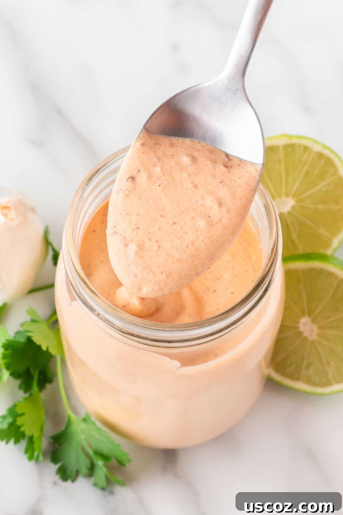 Smoky Ranch Kick 7 chipotle ranch dressing in a mason jar with a spoon