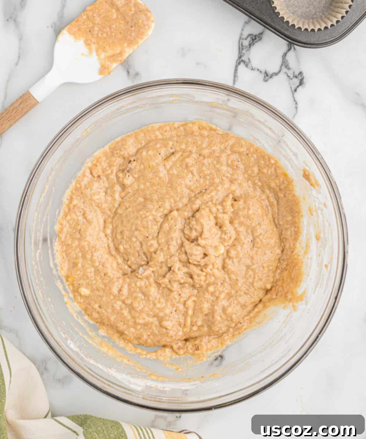 Homestyle Applesauce Muffins 8 Applesauce muffin batter, perfectly mixed with a few small lumps visible, indicating ideal consistency.