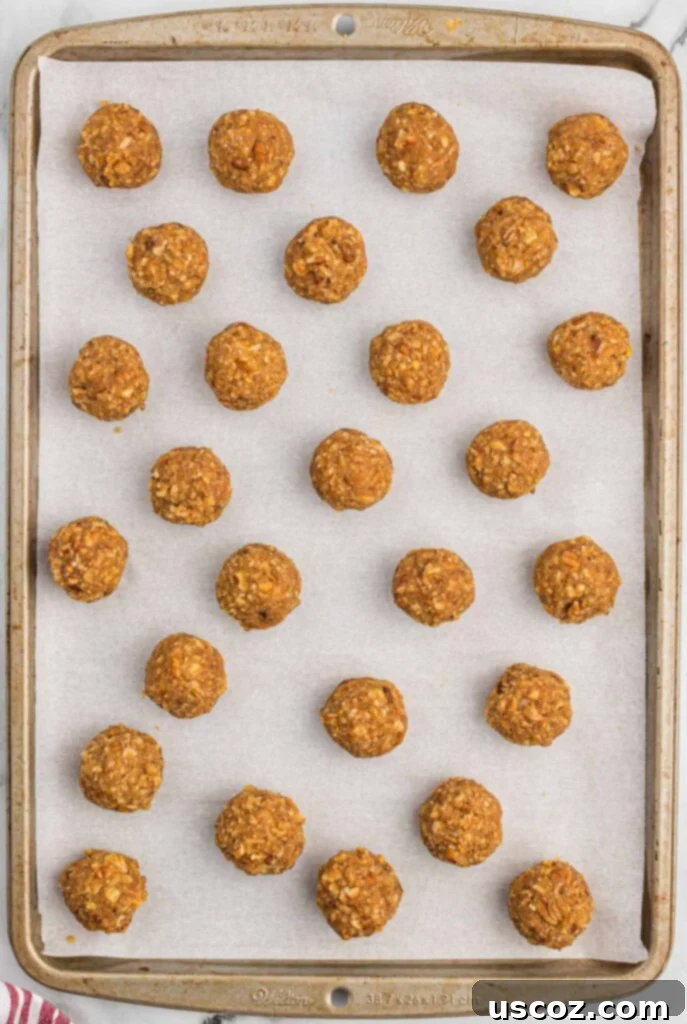Pecan Pie Truffles 8 pecan pie balls on a baking sheet before dipping