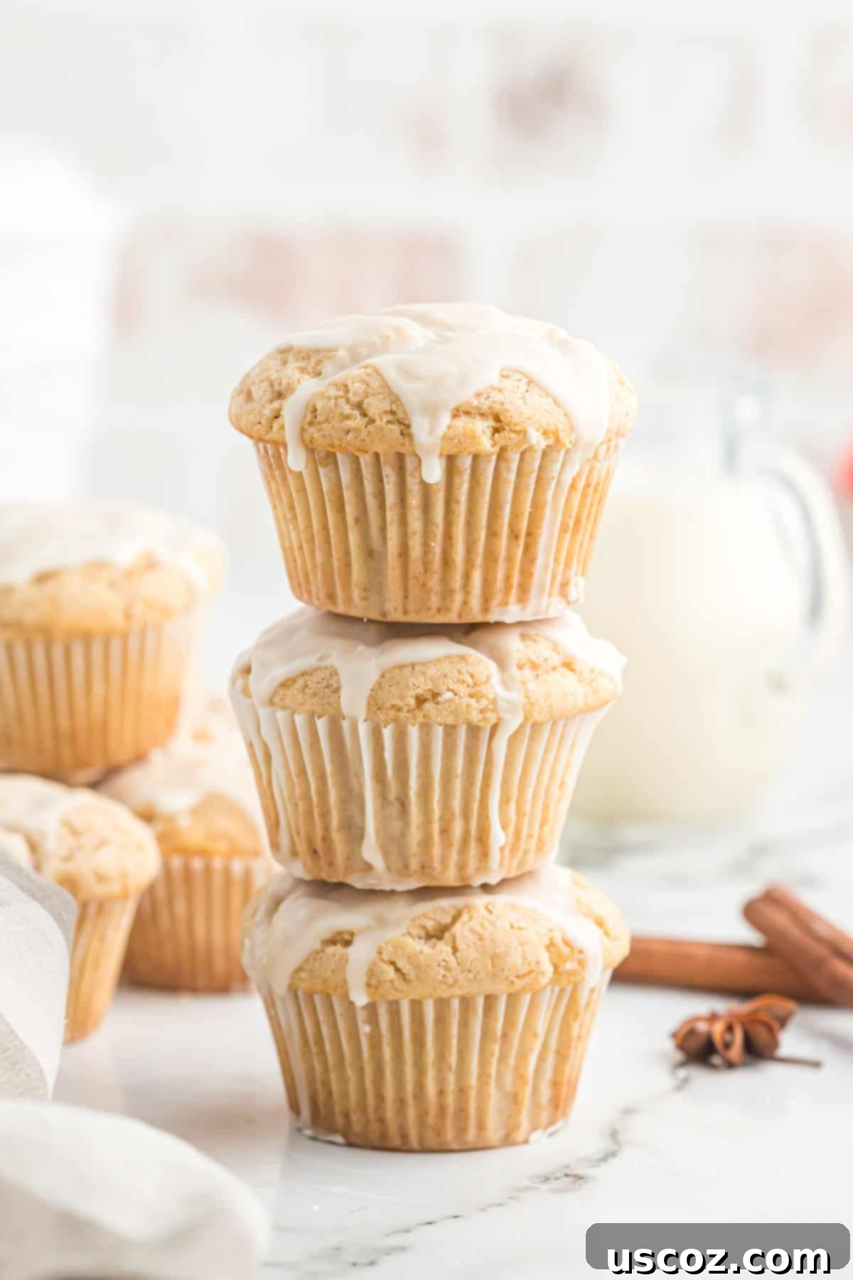 Holiday Eggnog Muffins 2 A stack of perfectly glazed eggnog muffins, ready to be enjoyed during the holiday season.