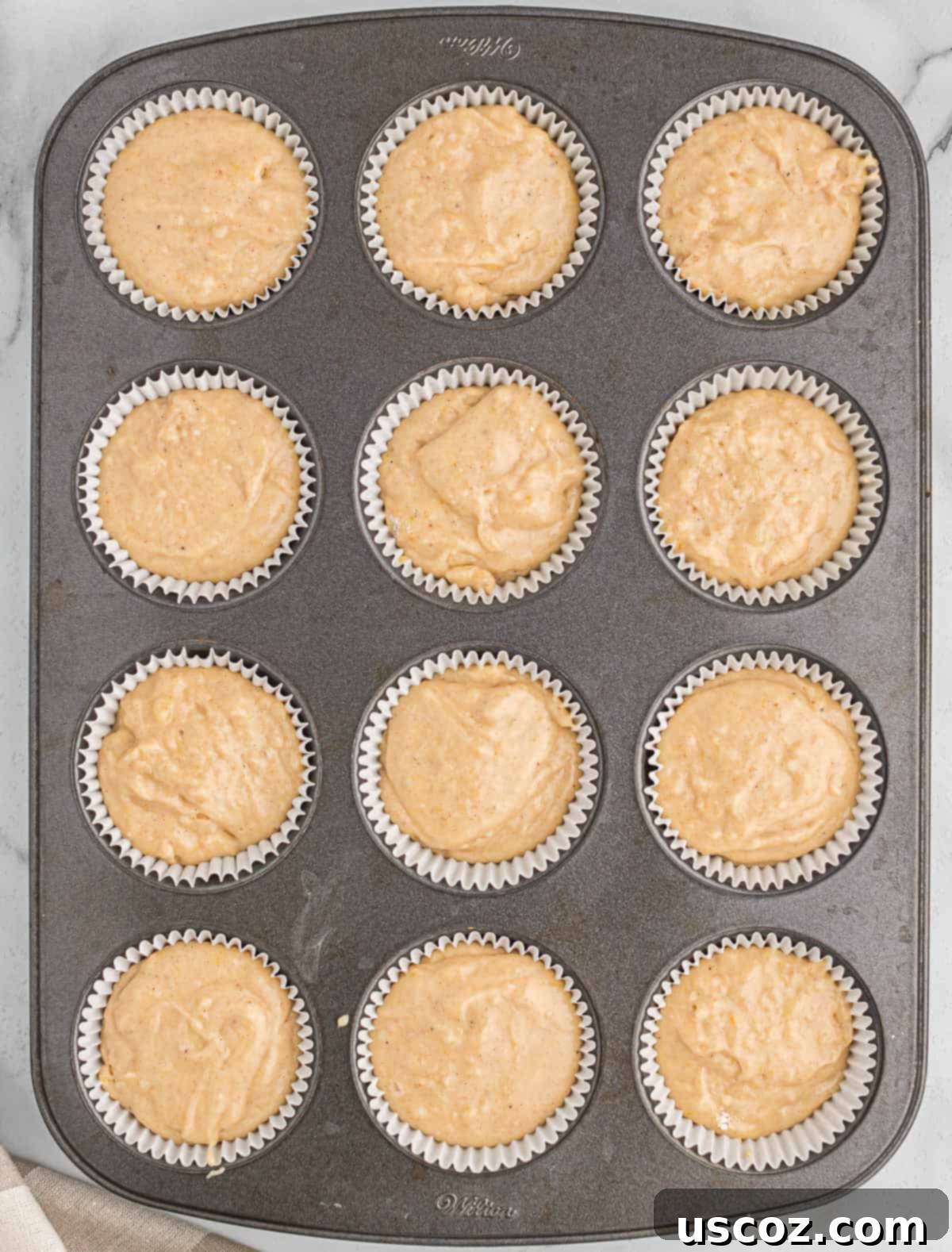 Holiday Eggnog Muffins 7 A muffin tin filled with eggnog batter, ready to go into the oven for baking.