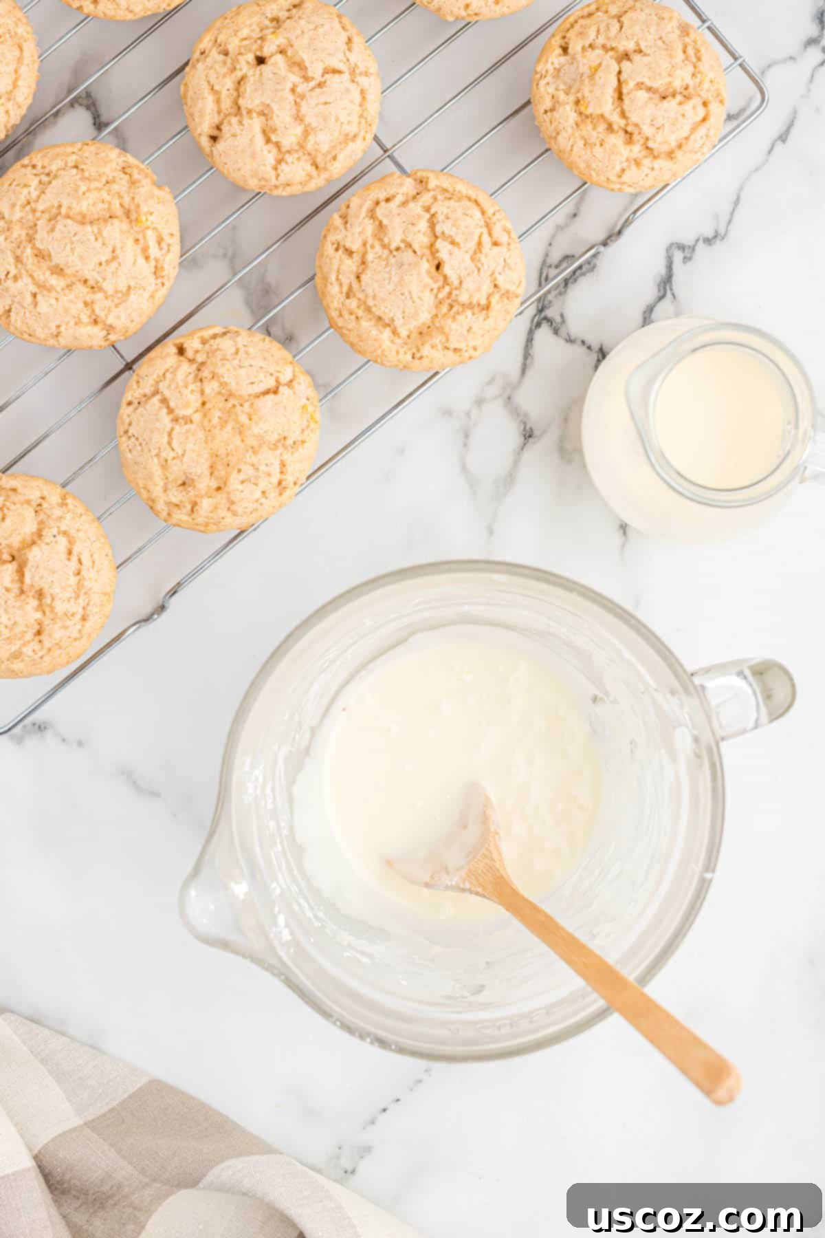 Holiday Eggnog Muffins 9 A bowl of powdered sugar and eggnog being whisked together to form the perfect, smooth glaze.