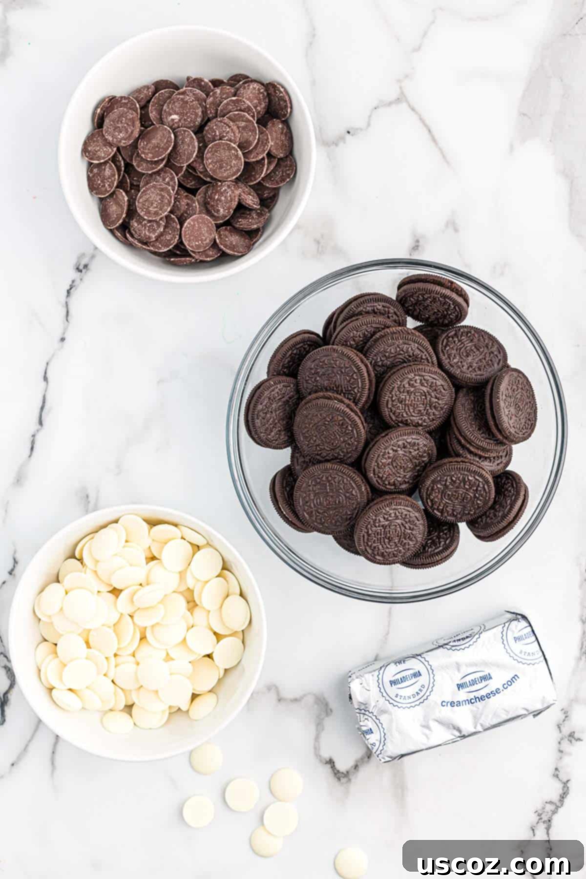 Oreo Truffles 3 A clear display of the minimal ingredients required to make delectable Oreo truffles: Oreo cookies, softened cream cheese, and both dark and white melting wafers.