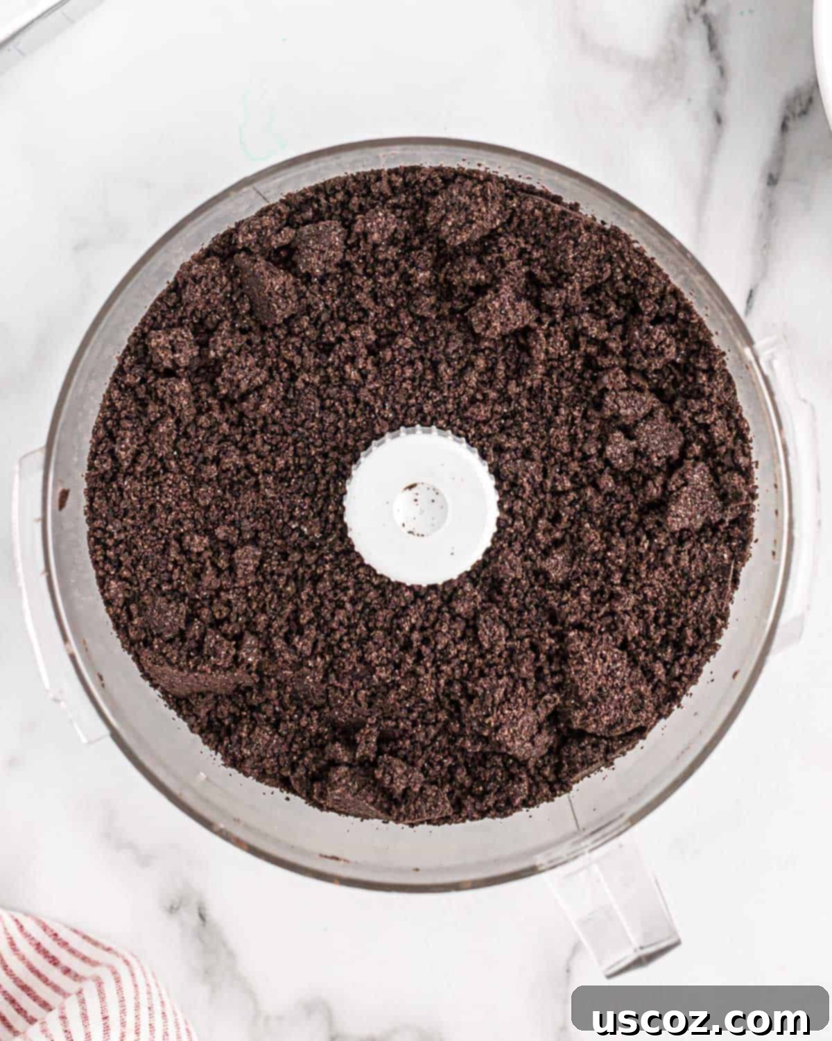 Oreo Truffles 4 Oreo cookies crushed into fine, uniform crumbs within a food processor, ready for the next mixing stage.