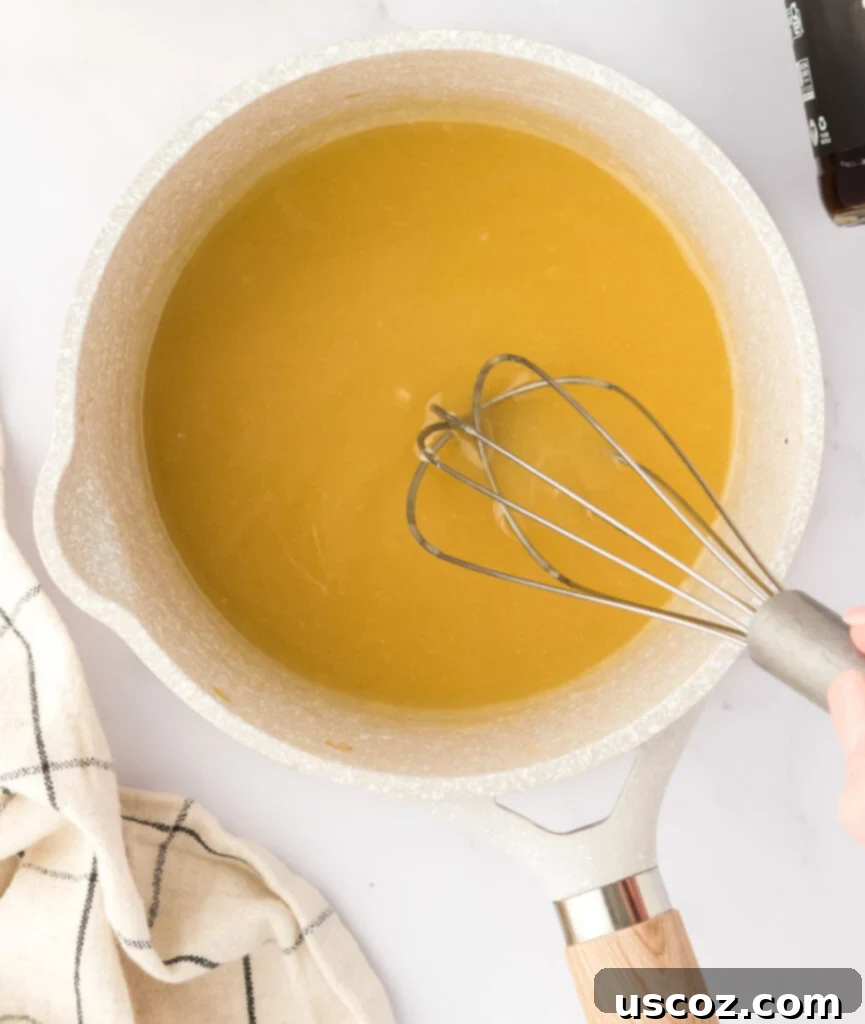 Perfect Vegetarian Gravy 15 A saucepan with a smooth, golden roux being actively whisked, creating the base for the gravy.