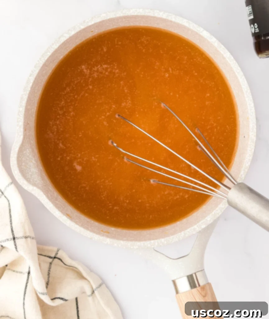 Perfect Vegetarian Gravy 16 Adding vegetable broth to the roux in a saucepan, whisking to combine.