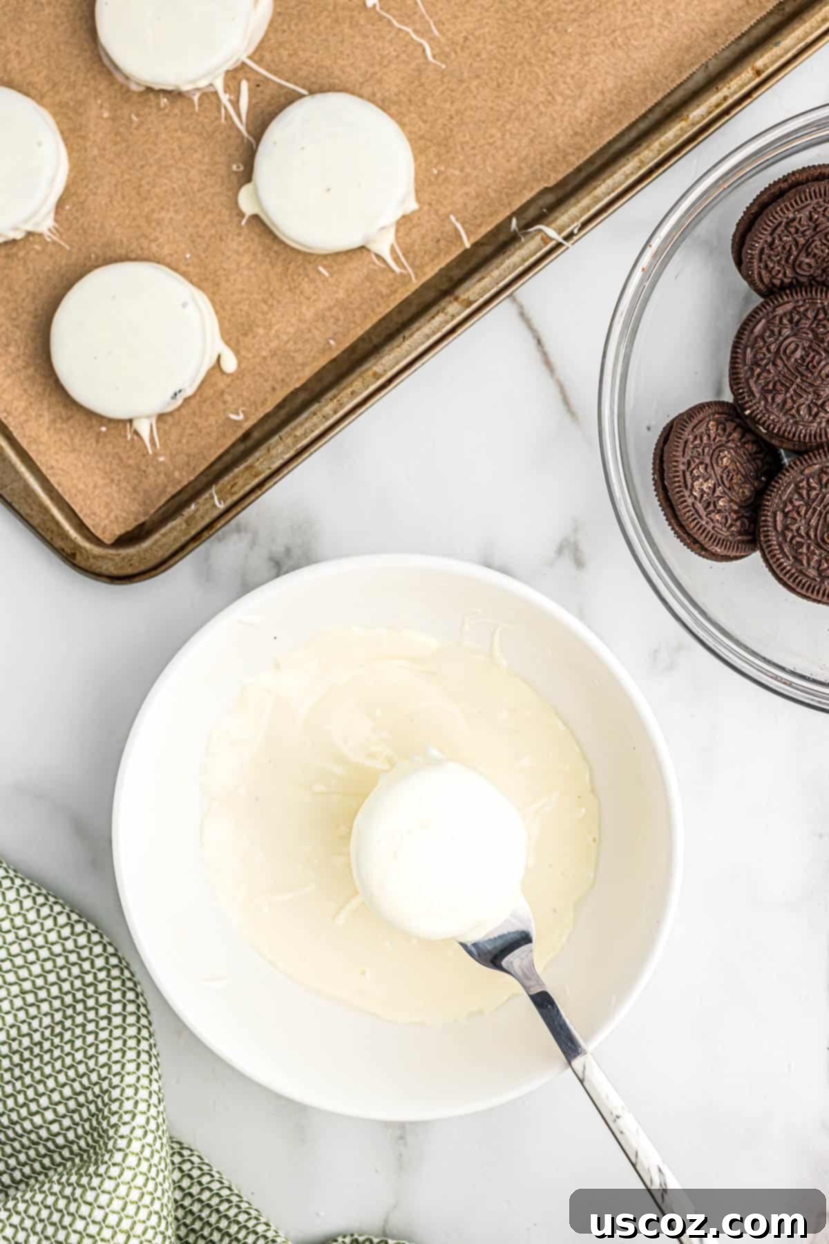 Decadent White Chocolate Oreos 5 dipping an oreo into melted white chocolate
