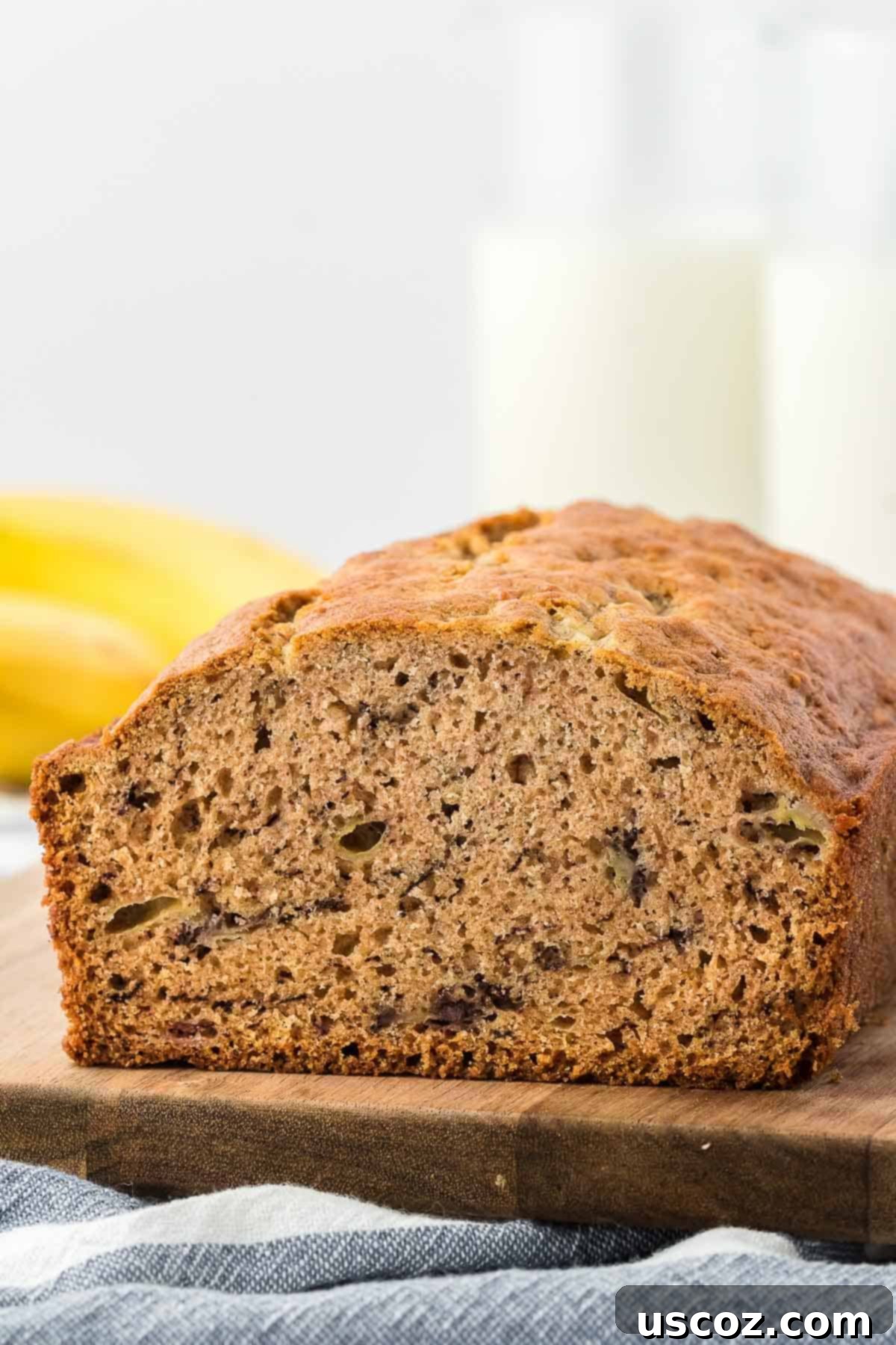 Ultimate Moist Banana Bread 15 A perfectly baked, golden-brown classic banana bread loaf resting on a wire cooling rack.