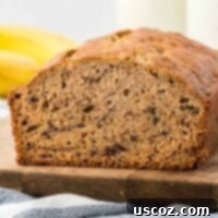 Ultimate Moist Banana Bread 18 A freshly baked classic banana bread loaf, golden brown and perfectly risen, cooling.