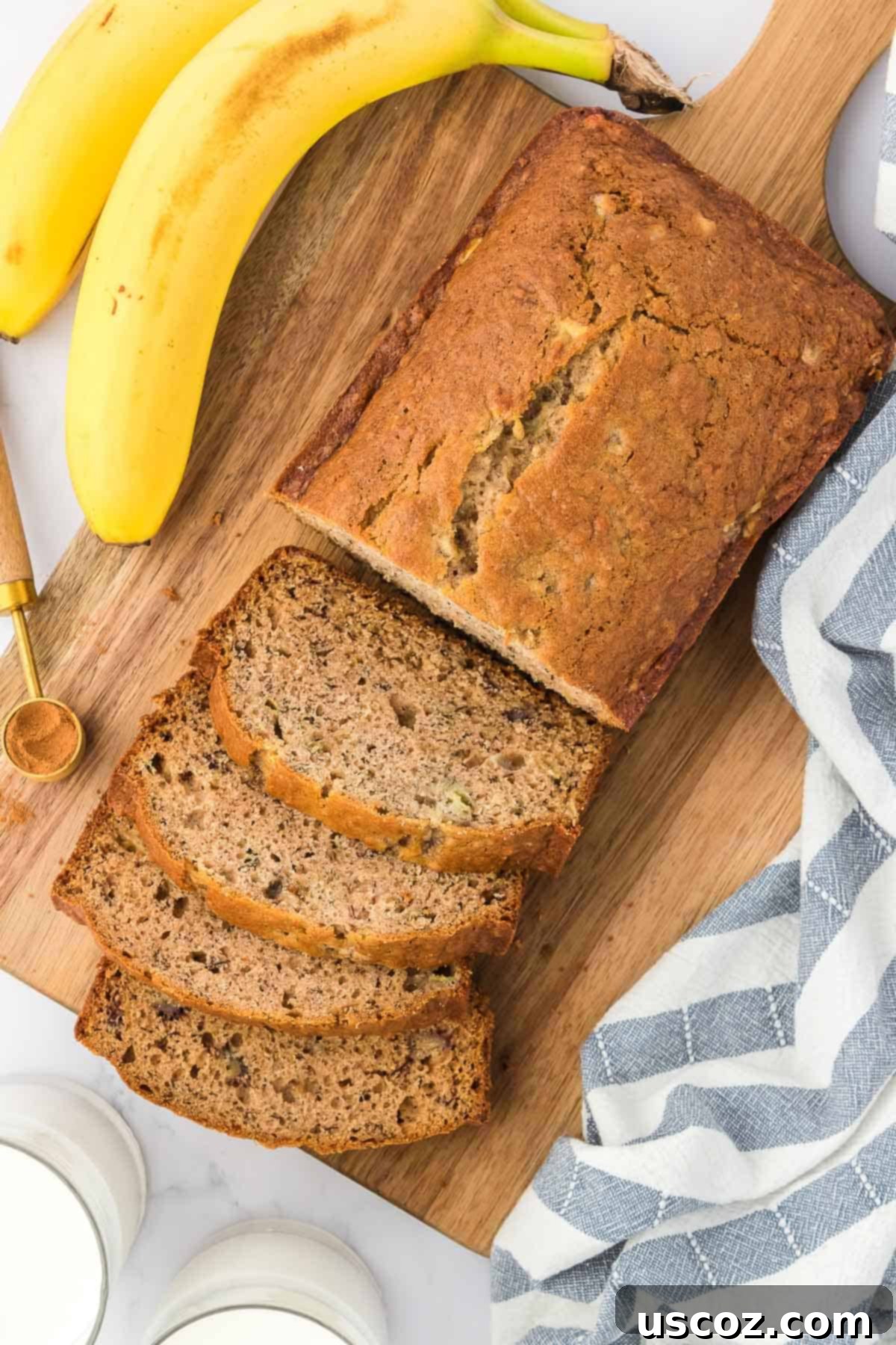 Ultimate Moist Banana Bread 3 A freshly baked loaf of classic banana bread, sliced to reveal its moist interior, inviting a bite.