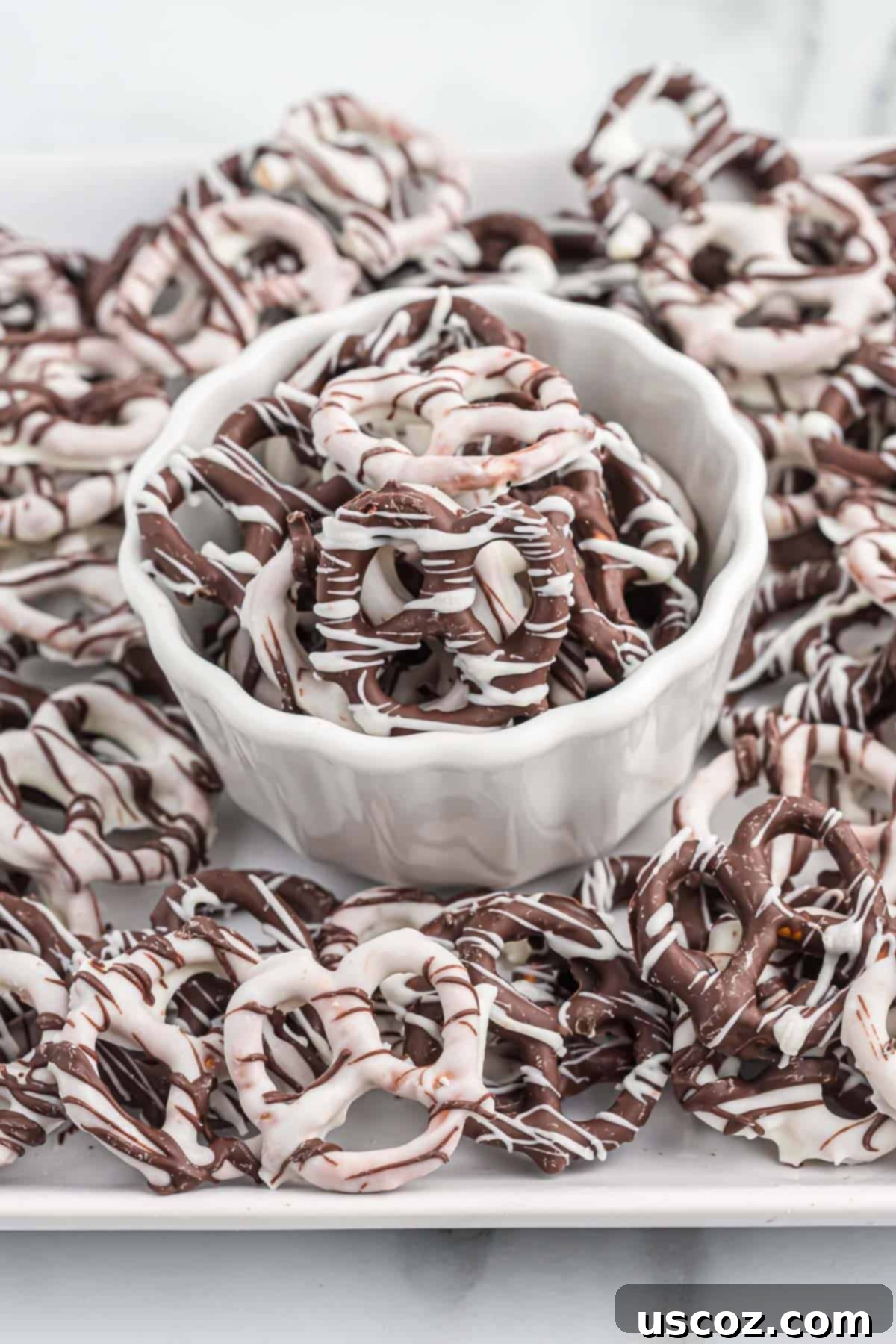 Chocolate Pretzel Perfection 2 A bowl overflowing with beautifully crafted chocolate covered pretzels, showcasing both dark and white chocolate varieties, making them an enticing snack.
