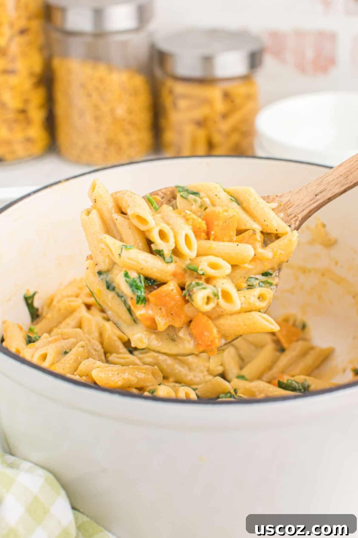 Golden Sweet Potato Strands 15 scooping sweet potato pasta from the dutch oven into a bowl