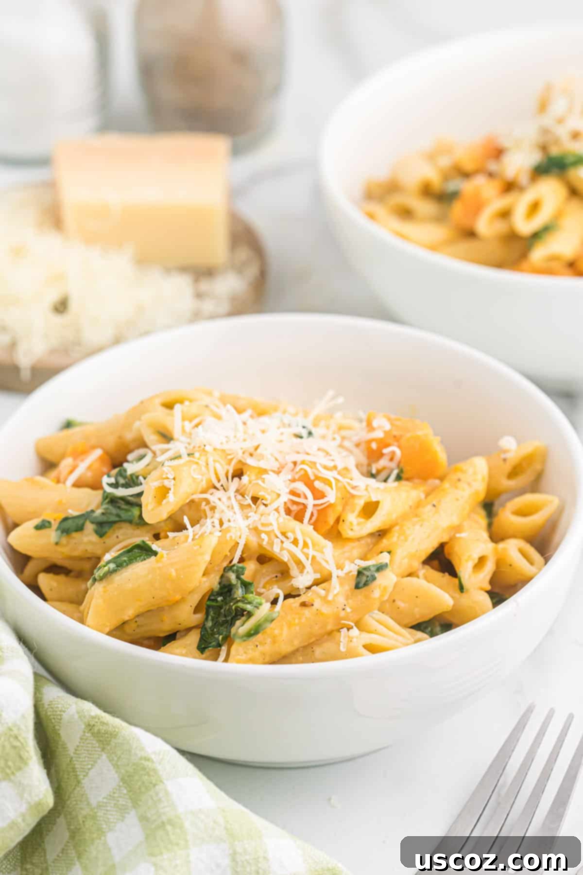 Golden Sweet Potato Strands 16 sweet potato pasta in a bowl topped with parmesan cheese and fresh herbs
