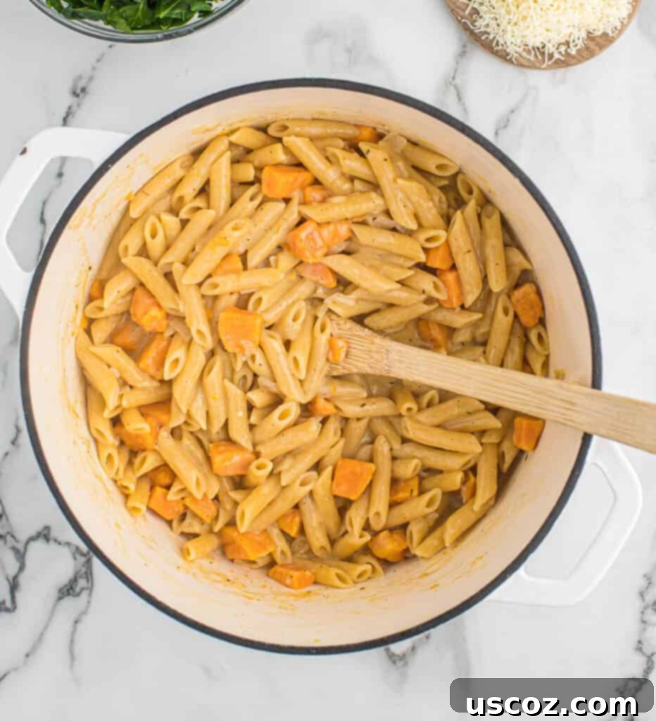 Golden Sweet Potato Strands 8 sweet potato pasta being stirred with sauce thickening