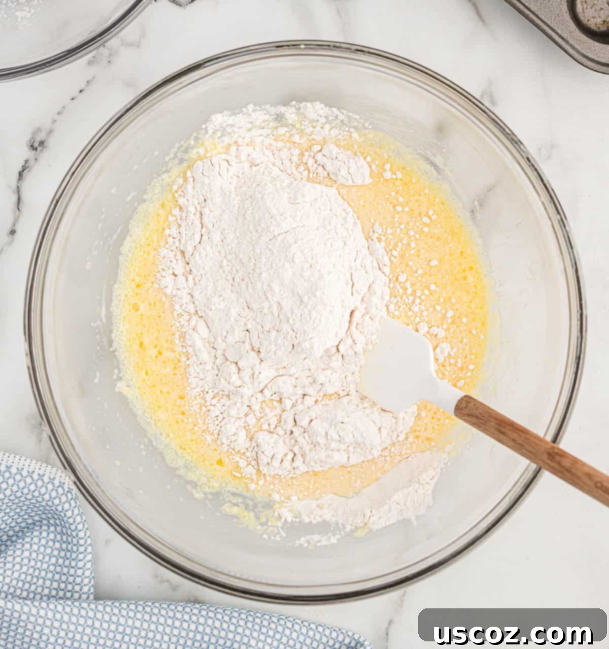 Breakfast Pancake Bites 6 Adding the dry ingredients to the wet ingredients in a mixing bowl, prior to gentle folding.