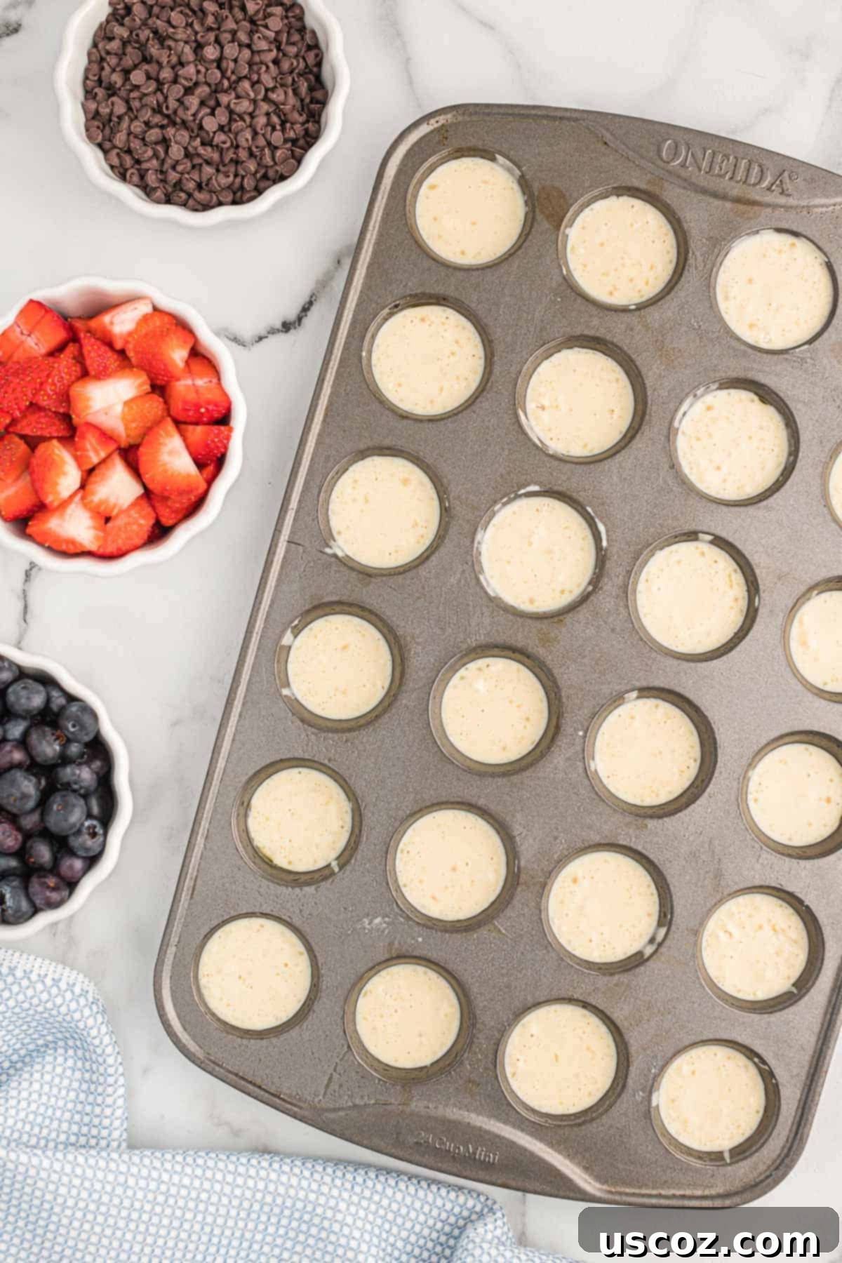 Breakfast Pancake Bites 8 A mini muffin tin filled with pancake batter, ready for toppings.